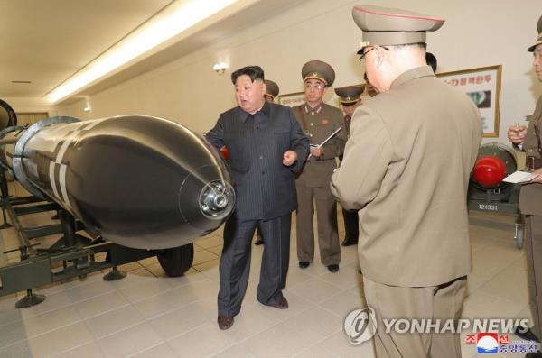 This photo, carried by North Korea's official Korean Central News Agency on March 28, 2023, shows North Korean leader Kim Jong-un (L) guiding the country's nuclear weapo<em></em>nization project the previous day, while calling for expanding the production of weapons-grade nuclear materials. (For Use o<em></em>nly in the Republic of Korea. No Redistribution) (Yonhap)