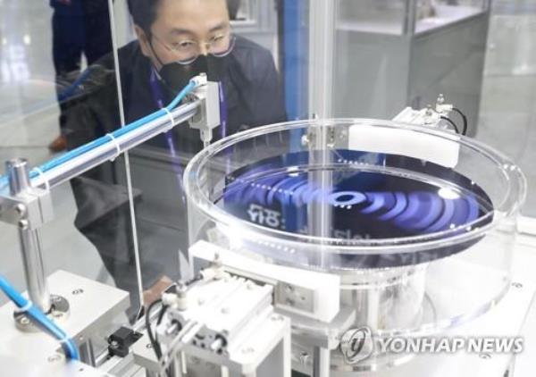 This file photo taken Feb. 9, 2022, shows an official demo<em></em>nstrating photoresist equipment during a semico<em></em>nductor exhibition in Seoul. (Yonhap)