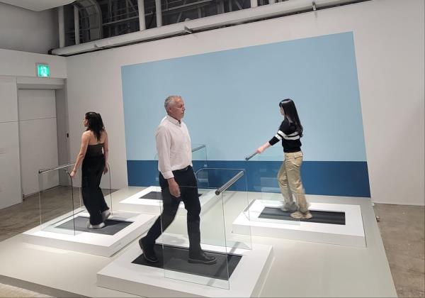 British pop artist Julian Opie walks on a treadmill installed at K1963, a culture and art space in the southeastern port city of Busan, during a press preview session on May 3, 2023. (Yonhap)