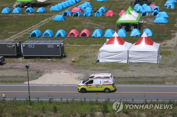 An ambulance takes people to the hospital after 88 participants at the 25th World Scout Jamboree needed medical attention, with most showing symptoms of heat-related illness, after the opening ceremony on Wednesday. (Yonhap)