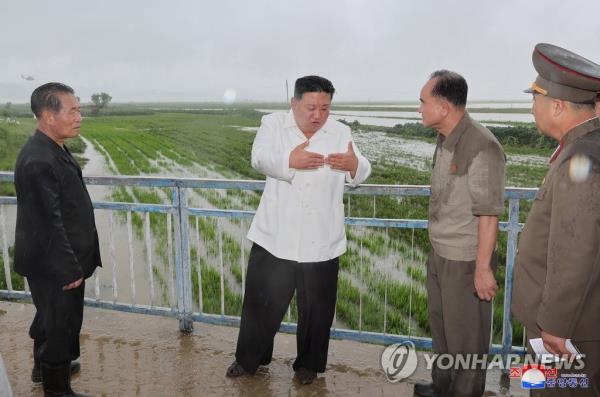 This photo, carried by the North's Korean Central News Agency on Aug. 14, 2023, shows North Korean leader Kim Jong-un (2nd from L) visiting Anbyon County, Kangwon Province, which suffered damage from Typhoon Khanun. (For Use o<em></em>nly in the Republic of Korea. No Redistribution) (Yonhap)