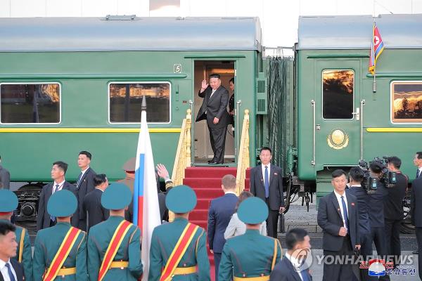 North Korean leader Kim Jong-un (rear) boards his special train after holding a summit with Russian President Vladimir Putin at the Vostochny Cosmodrome in the Russian Far East on Sept. 13, 2023, in this photo released by the North's official Korean Central News Agency the next day. Kim invited Putin to visit his country. (For Use o<em></em>nly in the Republic of Korea. No Redistribution) (Yonhap)
