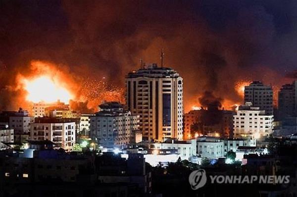 This Reuters photo shows flames and smoke billowing during Israeli strikes in Gaza on Oct. 9, 2023. (Yonhap)