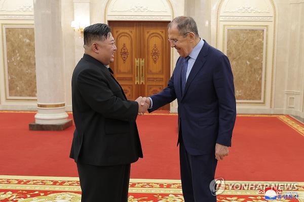 North Korean leader Kim Jong-un (L) shakes hands with Russian Foreign Minister Sergei Lavrov during their meeting in Pyo<em></em>ngyang on Oct. 19, 2023, in this photo carried by the North's official Korean Central News Agency the following day. (For Use o<em></em>nly in the Republic of Korea. No Redistribution) (Yonhap)