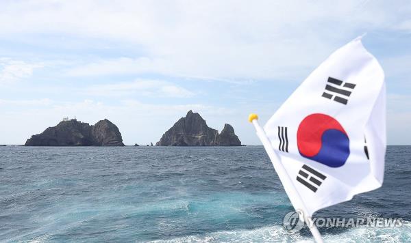 South Korea's natio<em></em>nal flag is seen next to the easternmost islets of Dokdo, in this file photo taken Oct. 23, 2023. (Yonhap)