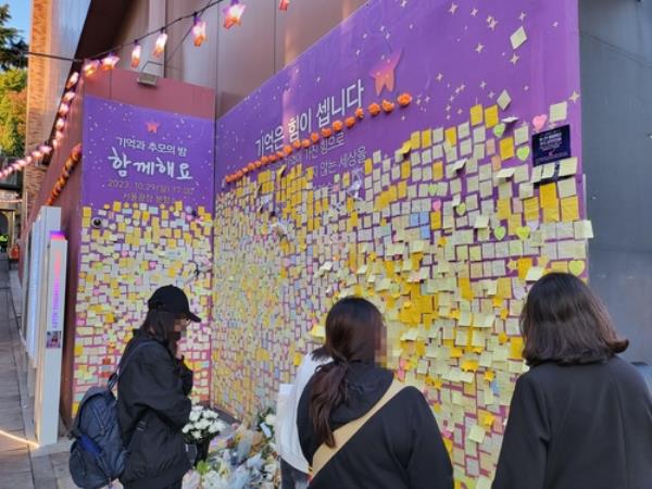 This photo, taken Oct. 28, 2023, shows people visiting a memorial wall in Seoul for the victims of the Halloween crowd crush in Itaewon that claimed 159 lives last year.