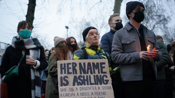 One mourner carries a placard that reads 'her name is Ashling' outside the Lo<em></em>ndon Irish Centre
