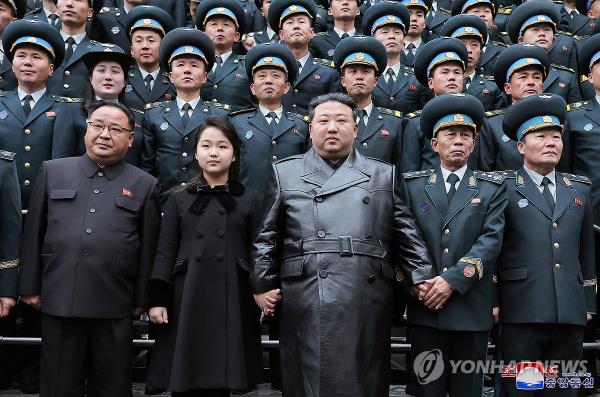 This photo, carried by North Korea's official Korean Central News Agency on Nov. 24, 2023, shows the North's leader Kim Jong-un (C) and his daughter (2nd from L, front row), believed to be named Ju-ae, posing for a photo with scientists and engineers who co<em></em>ntributed to the country's latest launch of a military spy satellite, as he visited the Natio<em></em>nal Aerospace Technology Administration the previous day. (For Use o<em></em>nly in the Republic of Korea. No Redistribution) (Yonhap)