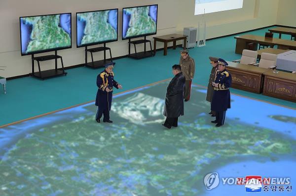 This photo, carried by North Korea's official Korea Central News Agency on Dec. 1, 2023, shows the North's leader Kim Jong-un visiting the Air Force Command on the previous day on the occasion of the Day of Airmen. (For Use o<em></em>nly in the Republic of Korea. No Redistribution) (Yonhap)
