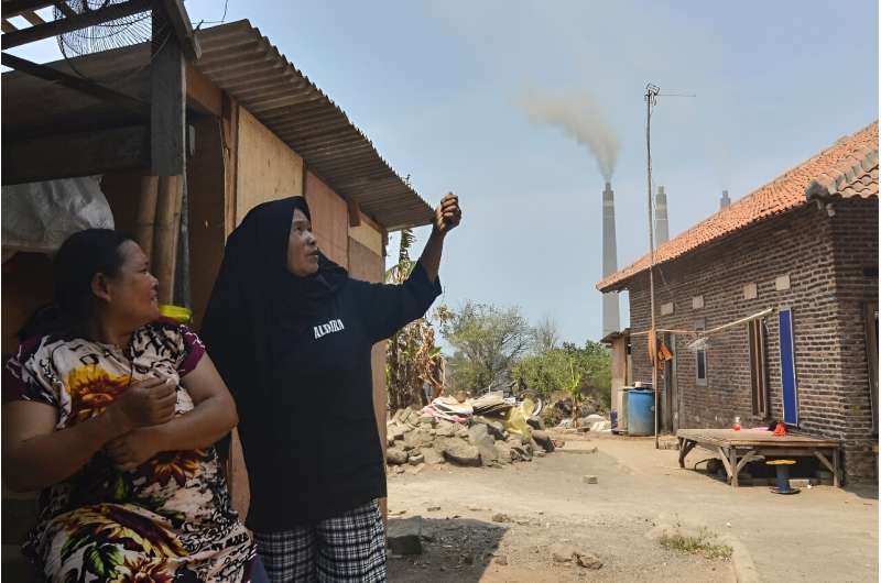 Local residents talk a<em></em>bout air pollution during an interview with AFP near the Suralaya coal-fired power plant in Cilegon, in Indonesia's Banten province