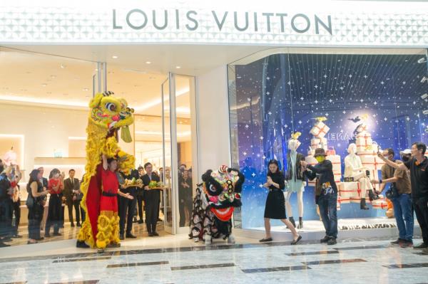 A lion dance performance in front of French luxury brand Louis Vuitton, located at the main entrance. — Picture by Raymond Manuel
